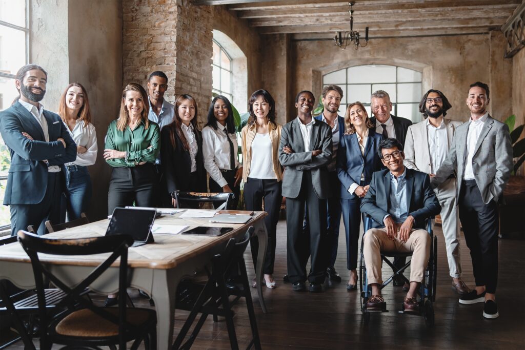 A diverse group of professionals posing confidently in a stylish office.