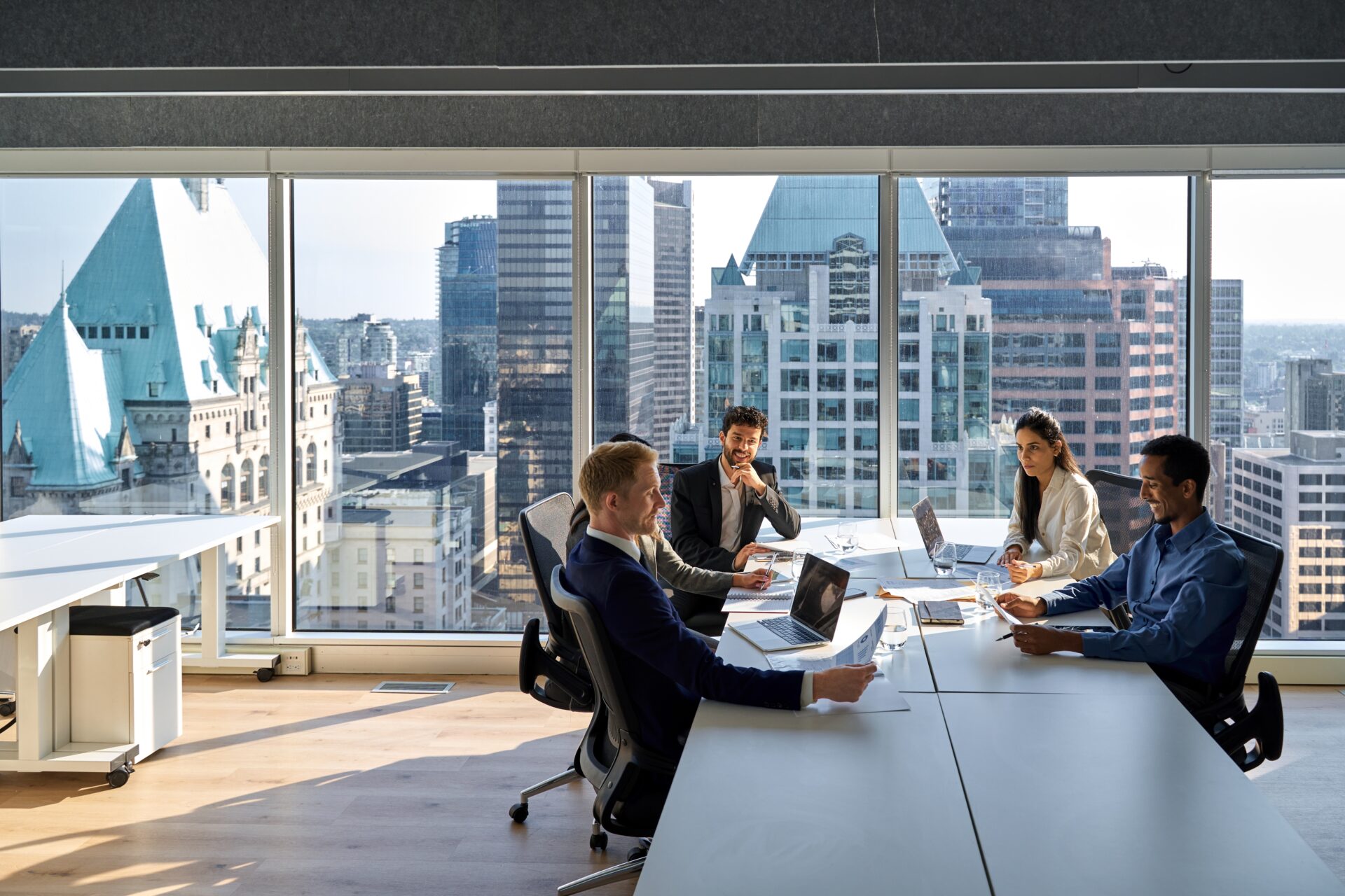 Business professionals collaborating in a modern office with city views.
