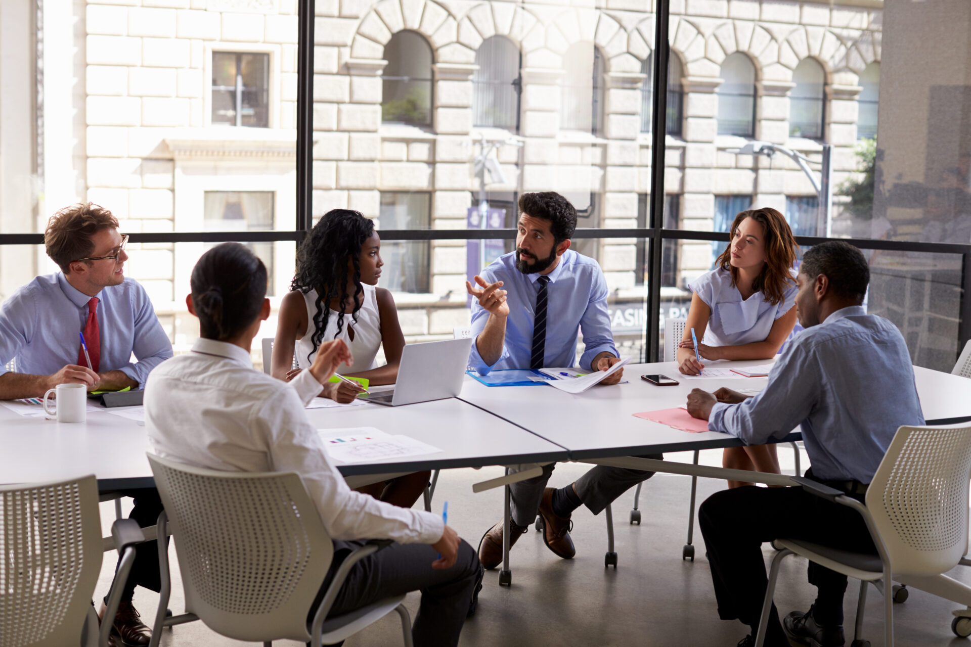 A diverse group of professionals collaborating around a conference table.