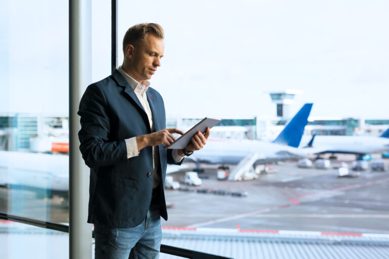 Businessman using a tablet at the airport terminal.