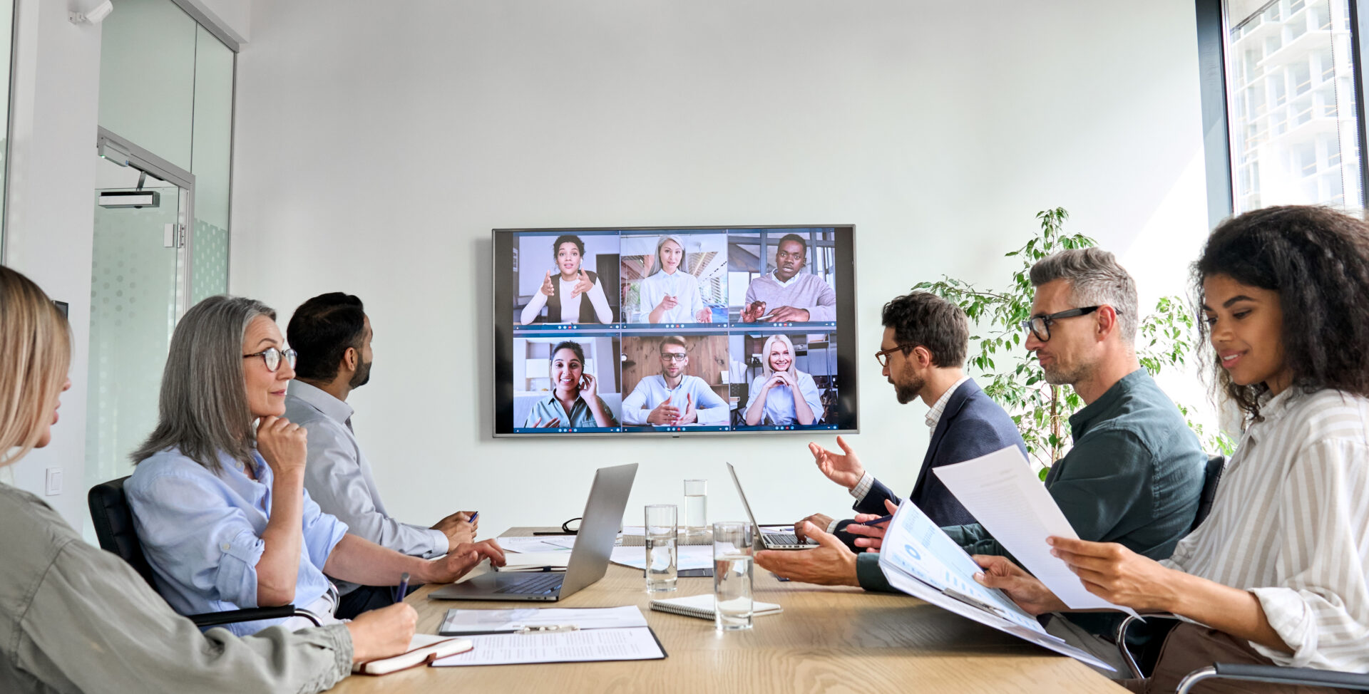 Video conference meeting in modern office setting.